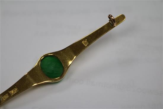 A Chinese yellow metal and jadeite cabochon bar brooch, 62mm.